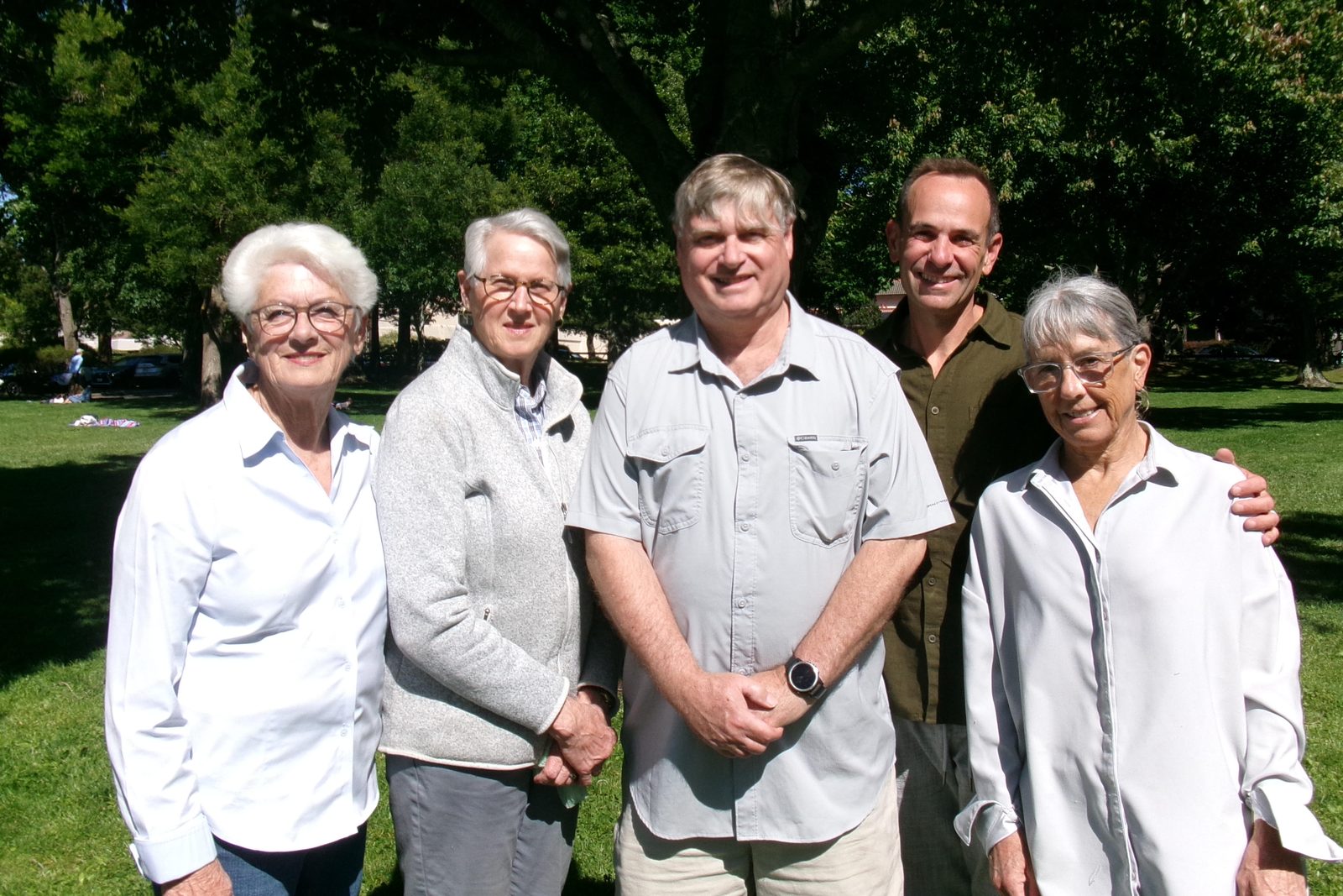 Five members of the Friends of the Lafayette-Moraga History Trail stand together on a sunny lawn beneath a large shade tree.